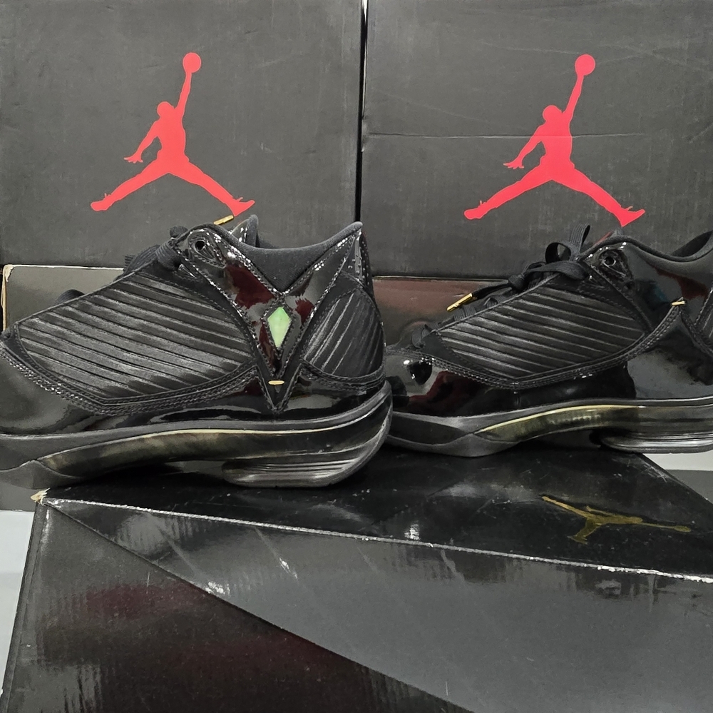 This is a pair of Air Jordan 2009 'S23' sneakers in the black and metallic gold